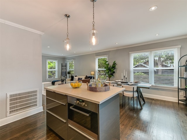 701 Bouldin Ave, Austin, TX 78704 - kitchen featuring stainless steel oven, recessed lighting, hanging light fixtures, dark wood-type flooring, and a kitchen island