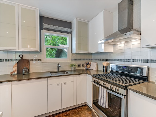 701 Bouldin Ave, Austin, TX 78704 - kitchen featuring stainless steel range with gas stovetop, wall chimney exhaust hood, dark countertops, and white cabinets