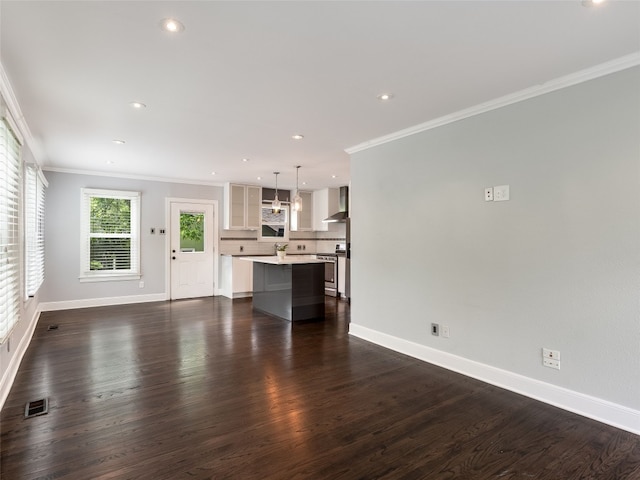 701 Bouldin Ave, Austin, TX 78704 - unfurnished living room with ornamental molding, recessed lighting, and dark wood-style floors