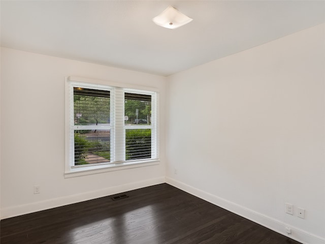 701 Bouldin Ave, Austin, TX 78704 - spare room featuring baseboards and dark wood-style floors