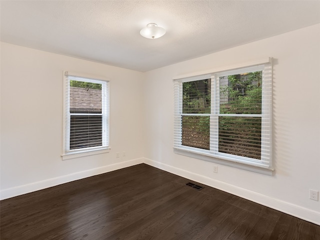 701 Bouldin Ave, Austin, TX 78704 - spare room featuring dark wood finished floors and baseboards
