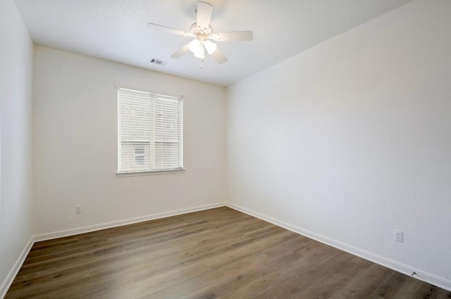 unfurnished room with wood finished floors, baseboards, and ceiling fan