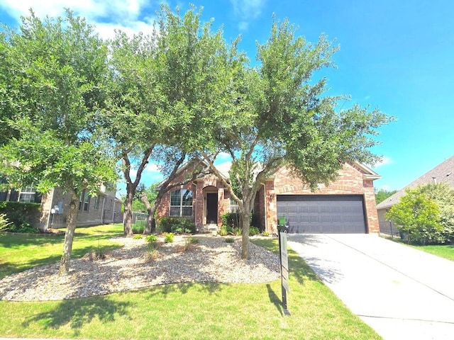 4924 Pyrenees Pass, Bee Cave, TX 78738 - view of property hidden behind natural elements featuring a garage, driveway, a front yard, and brick siding