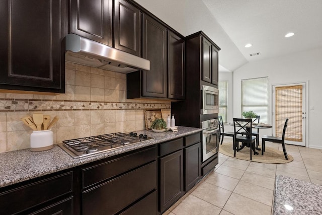 4924 Pyrenees Pass, Bee Cave, TX 78738 - kitchen featuring stainless steel appliances, under cabinet range hood, vaulted ceiling, backsplash, and light tile patterned floors