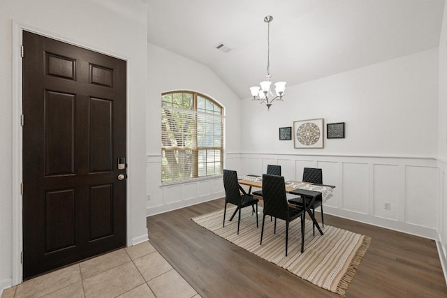 4924 Pyrenees Pass, Bee Cave, TX 78738 - dining area with a chandelier, lofted ceiling, wainscoting, wood finished floors, and a decorative wall