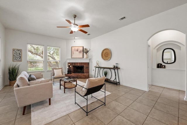 4924 Pyrenees Pass, Bee Cave, TX 78738 - living room featuring light tile patterned floors, ceiling fan, and a brick fireplace