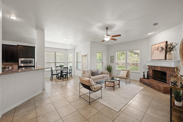 4924 Pyrenees Pass, Bee Cave, TX 78738 - living area with light tile patterned flooring, a fireplace, a ceiling fan, and recessed lighting
