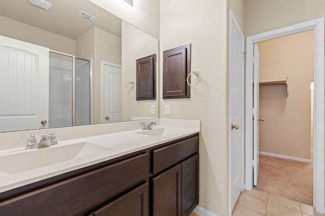 2880 Donnell Dr Unit 3903, Round Rock, TX 78664 - bathroom featuring a closet, tile patterned flooring, double vanity, a stall shower, and baseboards
