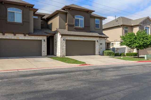 2880 Donnell Dr Unit 3903, Round Rock, TX 78664 - view of front of home featuring a garage, stone siding, concrete driveway, and stucco siding