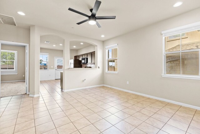 2880 Donnell Dr Unit 3903, Round Rock, TX 78664 - unfurnished living room featuring ceiling fan, recessed lighting, light tile patterned flooring, arched walkways, and baseboards