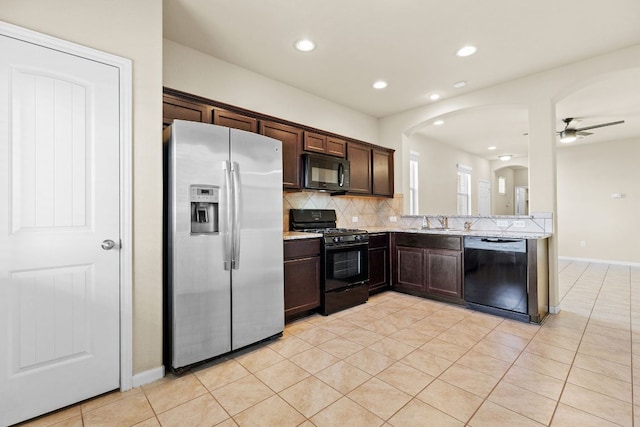 2880 Donnell Dr Unit 3903, Round Rock, TX 78664 - kitchen with black appliances, dark brown cabinetry, arched walkways, backsplash, and a sink