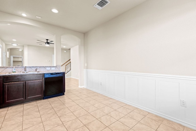 2880 Donnell Dr Unit 3903, Round Rock, TX 78664 - kitchen with dishwasher, arched walkways, a sink, ceiling fan, and wainscoting