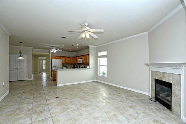 212 Yukon Ter, Georgetown, TX 78633 - unfurnished living room featuring ceiling fan, plenty of natural light, ornamental molding, a fireplace, and light tile patterned floors
