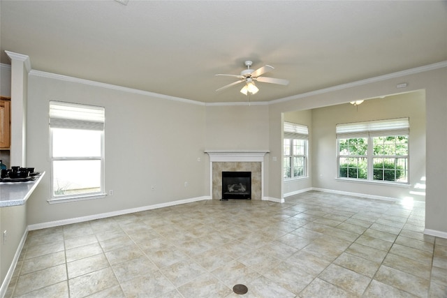 212 Yukon Ter, Georgetown, TX 78633 - unfurnished living room with ornamental molding, a ceiling fan, baseboards, light tile patterned floors, and a tiled fireplace