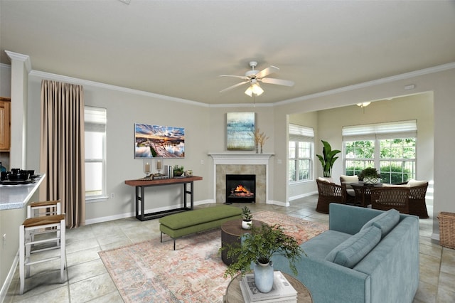 212 Yukon Ter, Georgetown, TX 78633 - living room with a ceiling fan, ornamental molding, light tile patterned floors, baseboards, and a fireplace