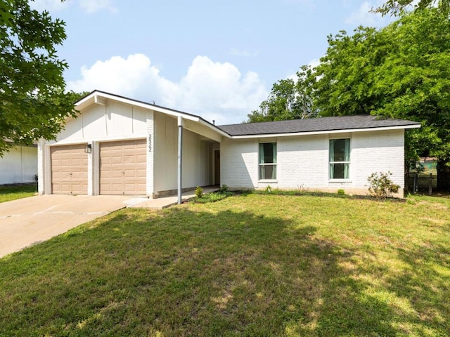ranch-style home featuring a garage, driveway, brick siding, a front lawn, and board and batten siding