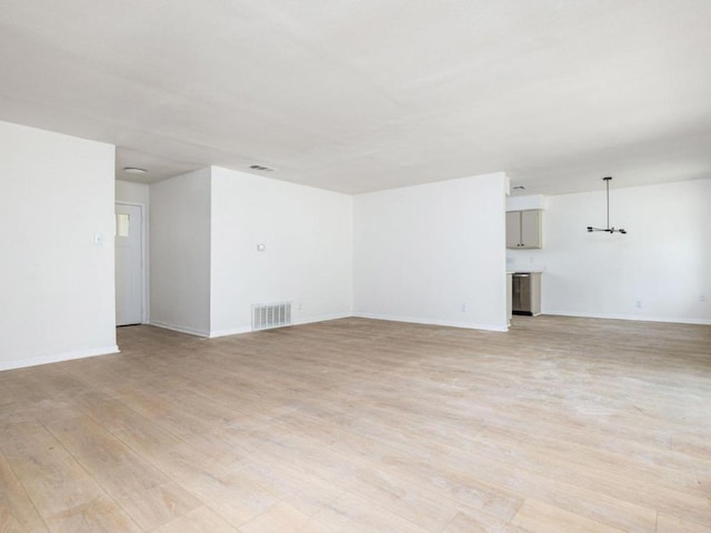 2522 Chaparral Trl, Austin, TX 78744 - unfurnished living room with light wood finished floors and a chandelier