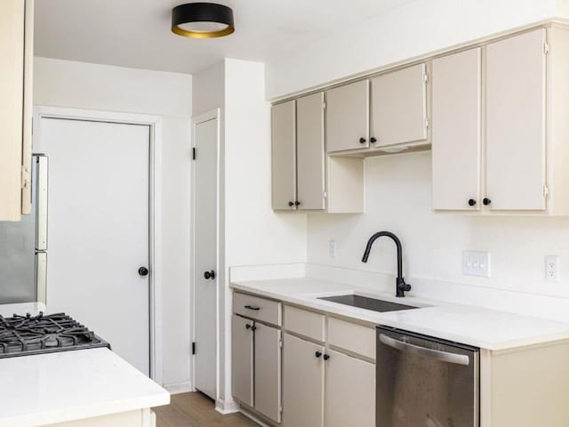 2522 Chaparral Trl, Austin, TX 78744 - kitchen with dishwasher, light countertops, freestanding refrigerator, and wood finished floors