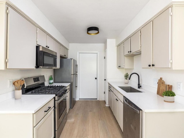 2522 Chaparral Trl, Austin, TX 78744 - kitchen with stainless steel appliances, light wood-style floors, and light countertops
