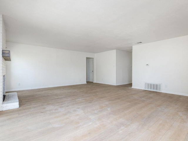 2522 Chaparral Trl, Austin, TX 78744 - unfurnished living room featuring light wood-style floors and a fireplace