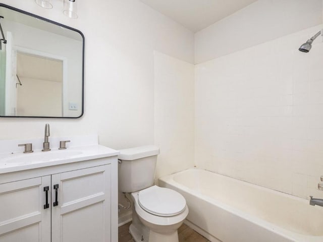 bathroom featuring toilet, vanity, and bathing tub / shower combination