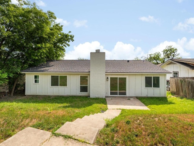 2522 Chaparral Trl, Austin, TX 78744 - back of house with board and batten siding, a chimney, a patio area, and a shingled roof