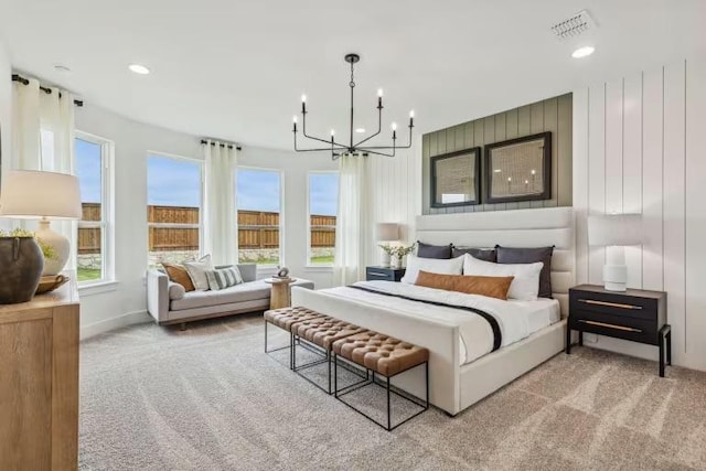 carpeted bedroom with a chandelier, recessed lighting, and baseboards