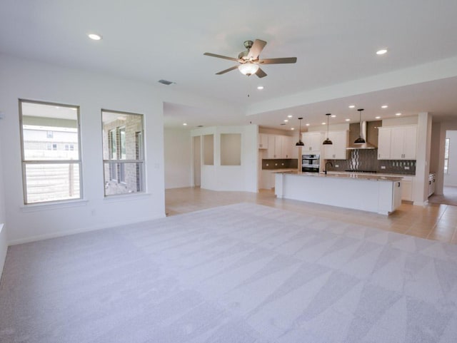 1709 Cayuga St, Leander, TX 78641 - unfurnished living room featuring light carpet, a sink, recessed lighting, a ceiling fan, and baseboards