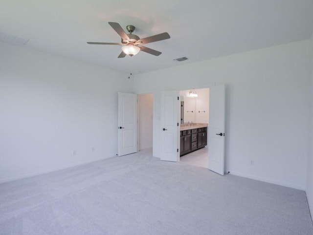 1709 Cayuga St, Leander, TX 78641 - unfurnished bedroom featuring light carpet, connected bathroom, baseboards, and a ceiling fan