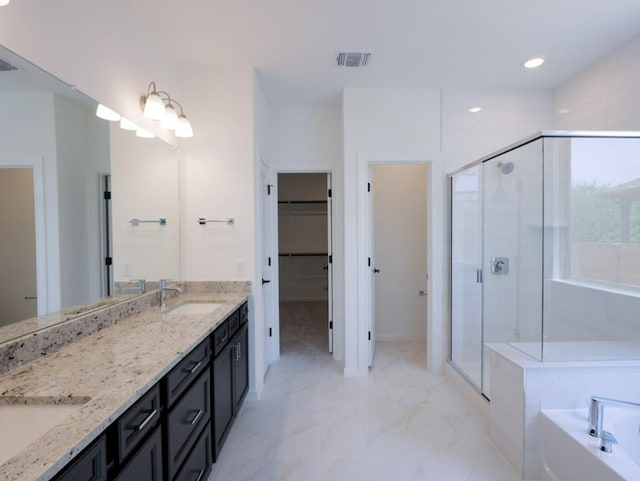 1709 Cayuga St, Leander, TX 78641 - bathroom with a shower stall, double vanity, a garden tub, marble look tile flooring, and recessed lighting