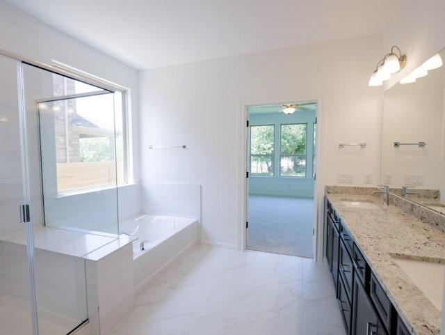 1709 Cayuga St, Leander, TX 78641 - full bath with double vanity, a bath, a stall shower, ceiling fan, and marble look tile flooring