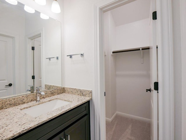 1709 Cayuga St, Leander, TX 78641 - bathroom with vanity, baseboards, and a spacious closet