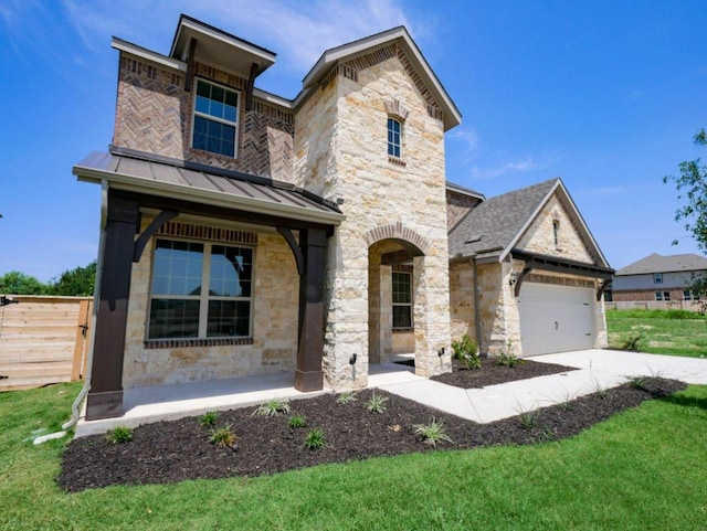 1709 Cayuga St, Leander, TX 78641 - view of front of house with stone siding, concrete driveway, a standing seam roof, and a garage