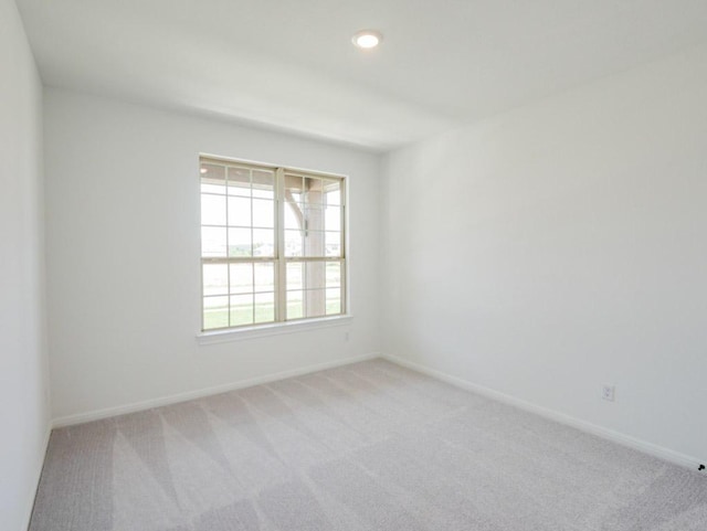 1709 Cayuga St, Leander, TX 78641 - empty room featuring light colored carpet, baseboards, and recessed lighting