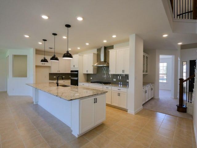 1709 Cayuga St, Leander, TX 78641 - kitchen with wall chimney range hood, a sink, black appliances, decorative backsplash, and white cabinets
