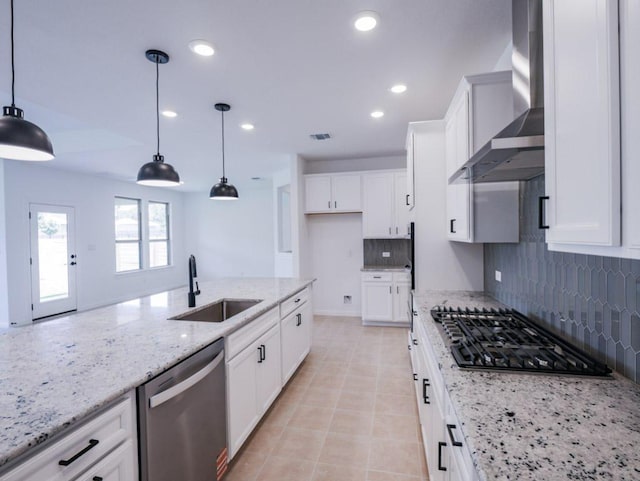 1709 Cayuga St, Leander, TX 78641 - kitchen featuring a sink, appliances with stainless steel finishes, wall chimney exhaust hood, backsplash, and light stone countertops