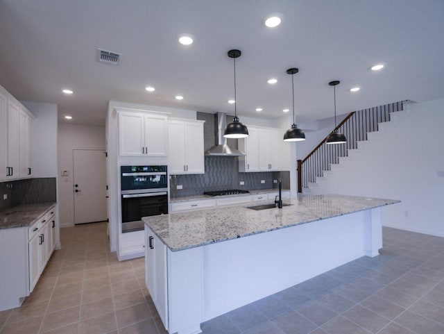 1709 Cayuga St, Leander, TX 78641 - kitchen featuring wall chimney exhaust hood, a sink, black gas cooktop, stainless steel double oven, and backsplash