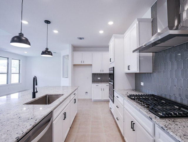 1709 Cayuga St, Leander, TX 78641 - kitchen with wall chimney exhaust hood, a sink, stainless steel appliances, white cabinets, and decorative backsplash