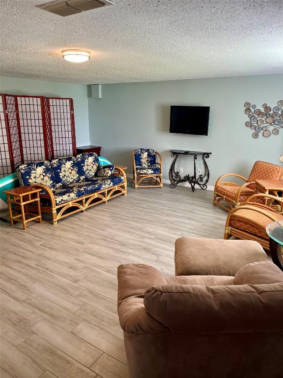 103 Island Dr Unit 8, Horseshoe Bay, TX 78657 - living area with wood finished floors and a textured ceiling