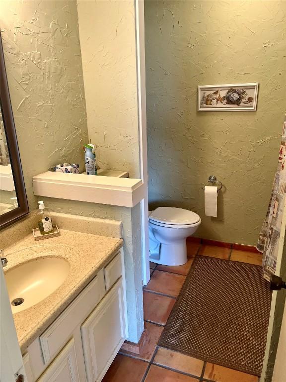 103 Island Dr Unit 8, Horseshoe Bay, TX 78657 - bathroom featuring tile patterned floors, toilet, and vanity