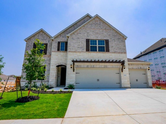 2916 Carrizo Ter, Leander, TX 78641 - view of front of house featuring driveway, a front lawn, an attached garage, stone siding, and brick siding