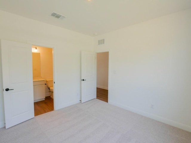 2916 Carrizo Ter, Leander, TX 78641 - unfurnished bedroom with carpet flooring, baseboards, and connected bathroom