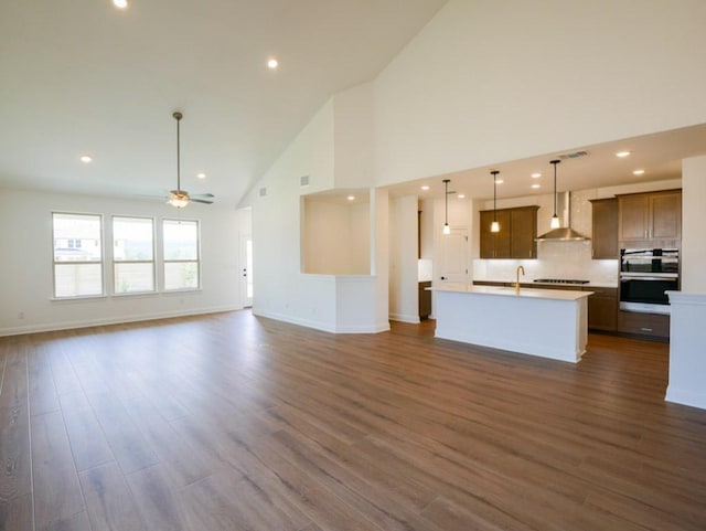 2916 Carrizo Ter, Leander, TX 78641 - unfurnished living room with high vaulted ceiling, ceiling fan, dark wood finished floors, recessed lighting, and baseboards