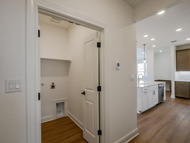 2916 Carrizo Ter, Leander, TX 78641 - laundry area featuring dark wood-style flooring, hookup for a washing machine, electric dryer hookup, baseboards, and recessed lighting