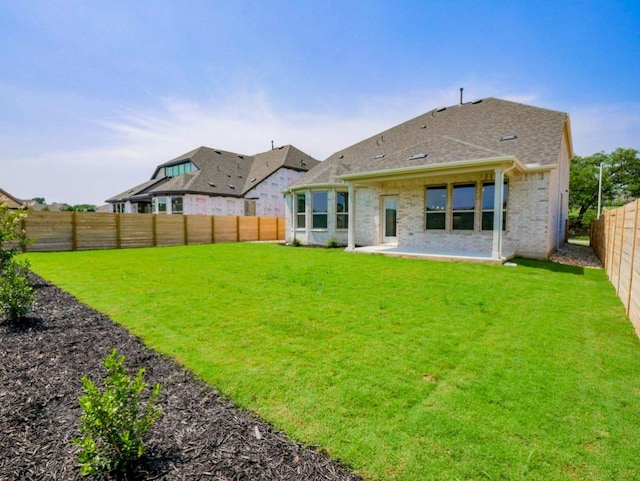 2916 Carrizo Ter, Leander, TX 78641 - rear view of house featuring a patio area, brick siding, and roof with shingles