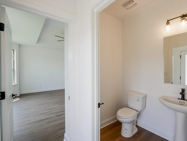 2916 Carrizo Ter, Leander, TX 78641 - bathroom featuring wood finished floors, toilet, baseboards, and a sink