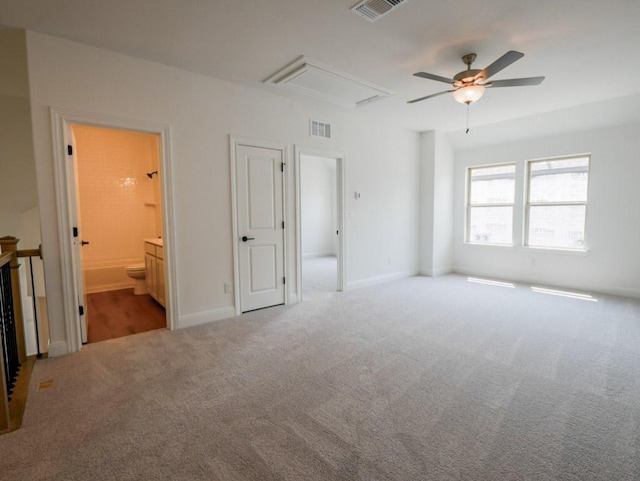 2916 Carrizo Ter, Leander, TX 78641 - unfurnished bedroom with attic access, carpet, ensuite bath, baseboards, and a ceiling fan