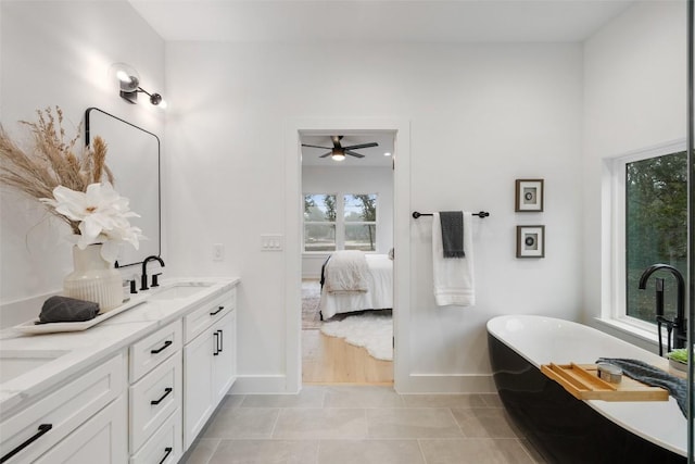 TBD Rust Ranch Rd, Blanco, TX 78606 - ensuite bathroom featuring baseboards, double vanity, a freestanding tub, and ceiling fan
