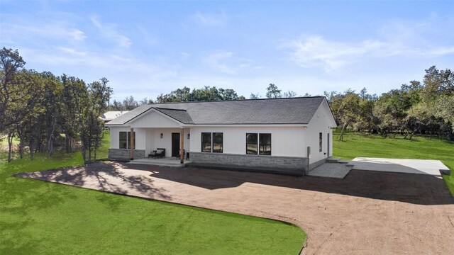 TBD Rust Ranch Rd, Blanco, TX 78606 - rear view of property with a lawn, a patio area, a shingled roof, and board and batten siding