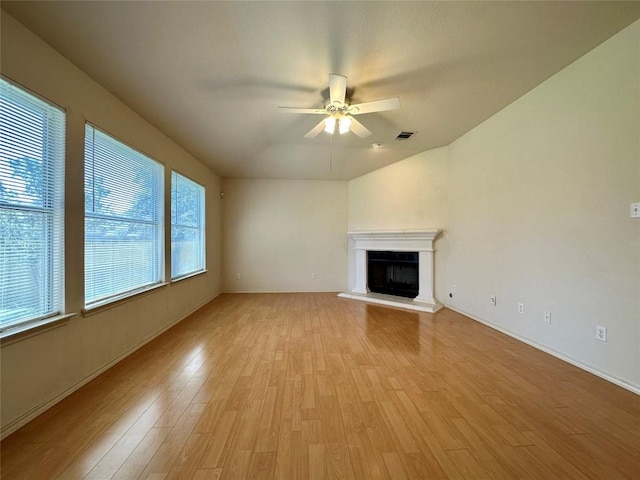 4526 Tello Path, Austin, TX 78749 - unfurnished living room with light wood-type flooring, ceiling fan, a fireplace with raised hearth, and baseboards